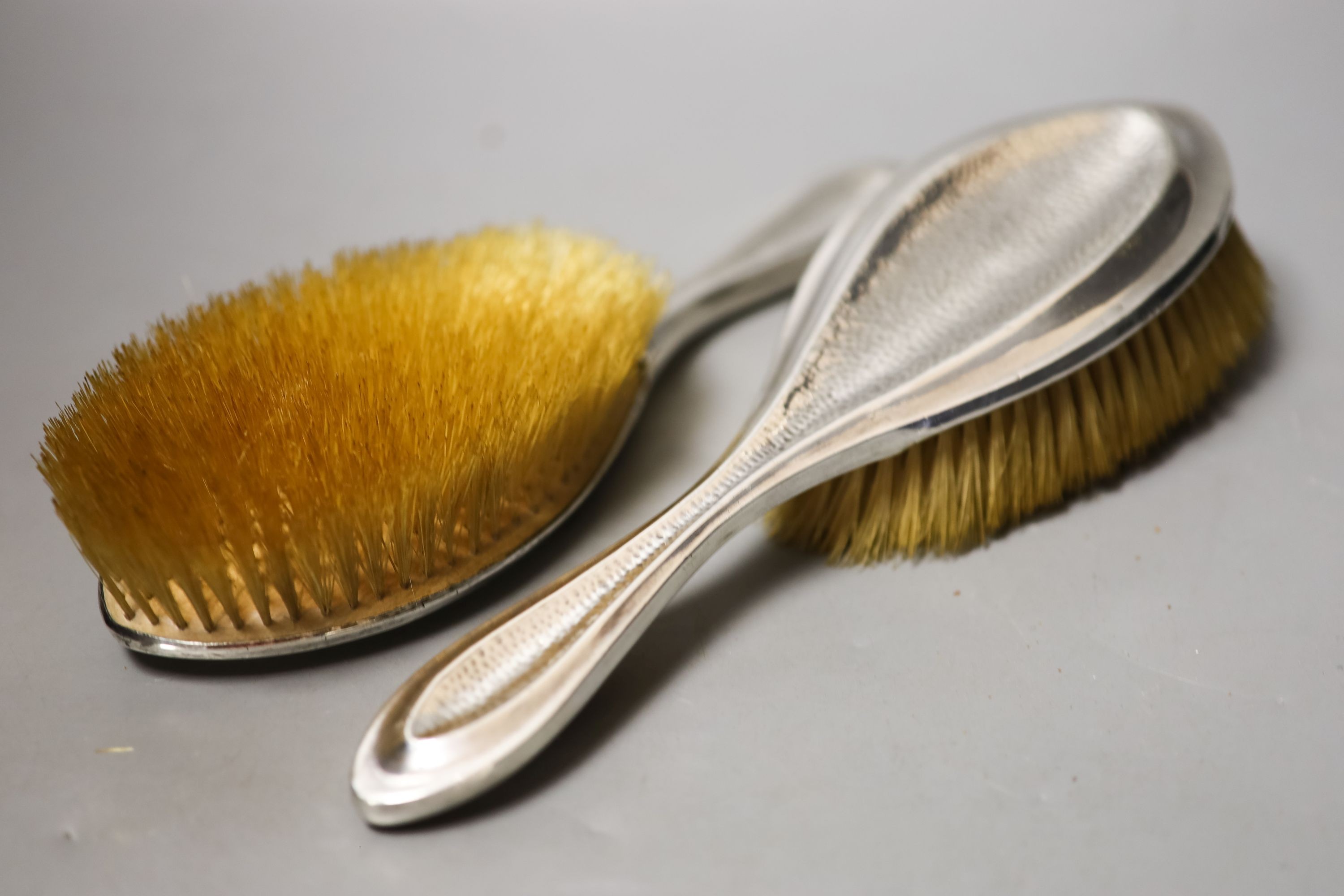 An Edwardian matched part planished silver five piece mirror and brush set, Saunders & Shepherd, Birmingham, 1907/8(4) and Chester, 1908.